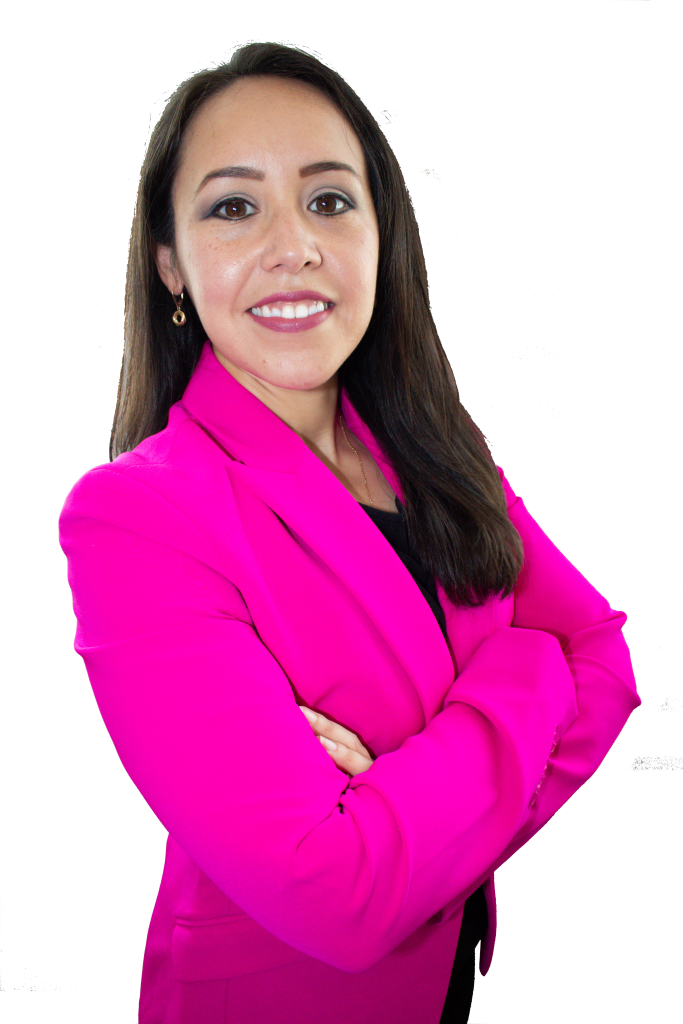 A woman in a pink blazer with her arms crossed.